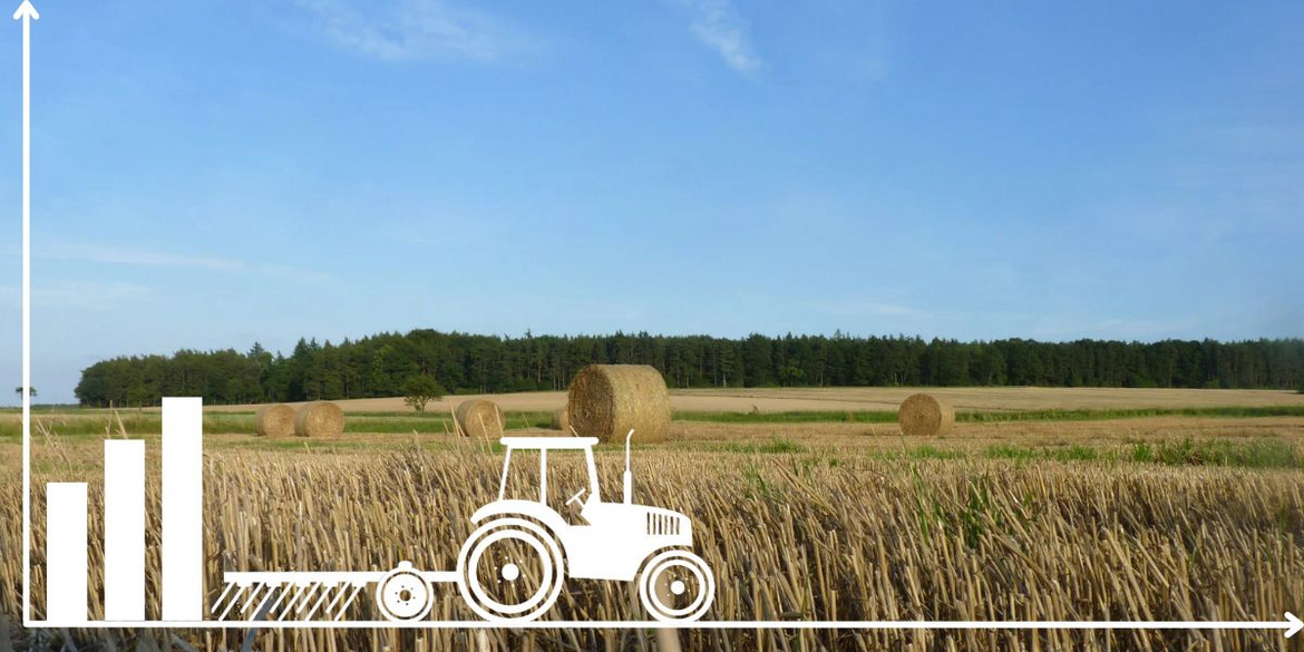 Traktor vor abgeernteten Feld